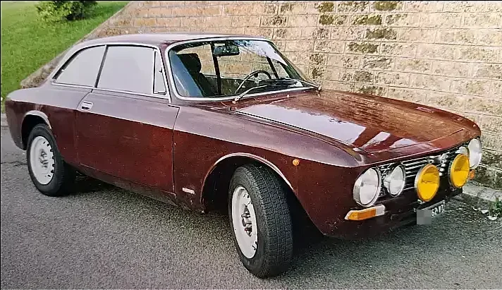 Alfa Romeo GT 1300 cc Junior, dark red, in good condition, front three-quarter shot.