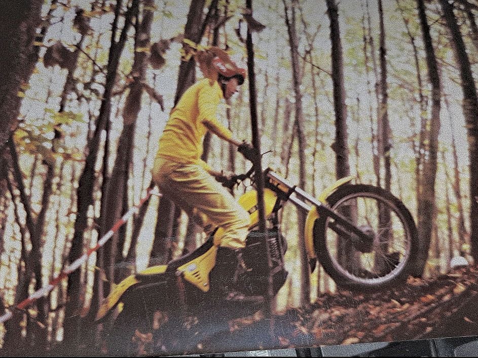 SWM TL 320 trial motorcycle, yellow colour, in the forest, climbing a hill.