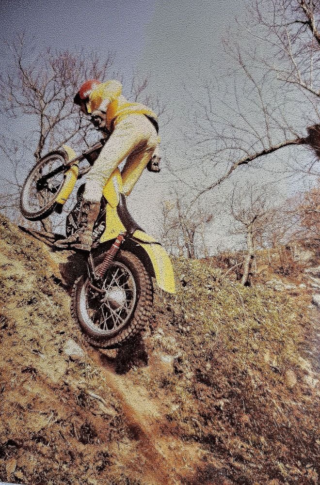 Paolo is challenging a climb with the SWM, in a trial section in the forest on a beautiful sunny day.